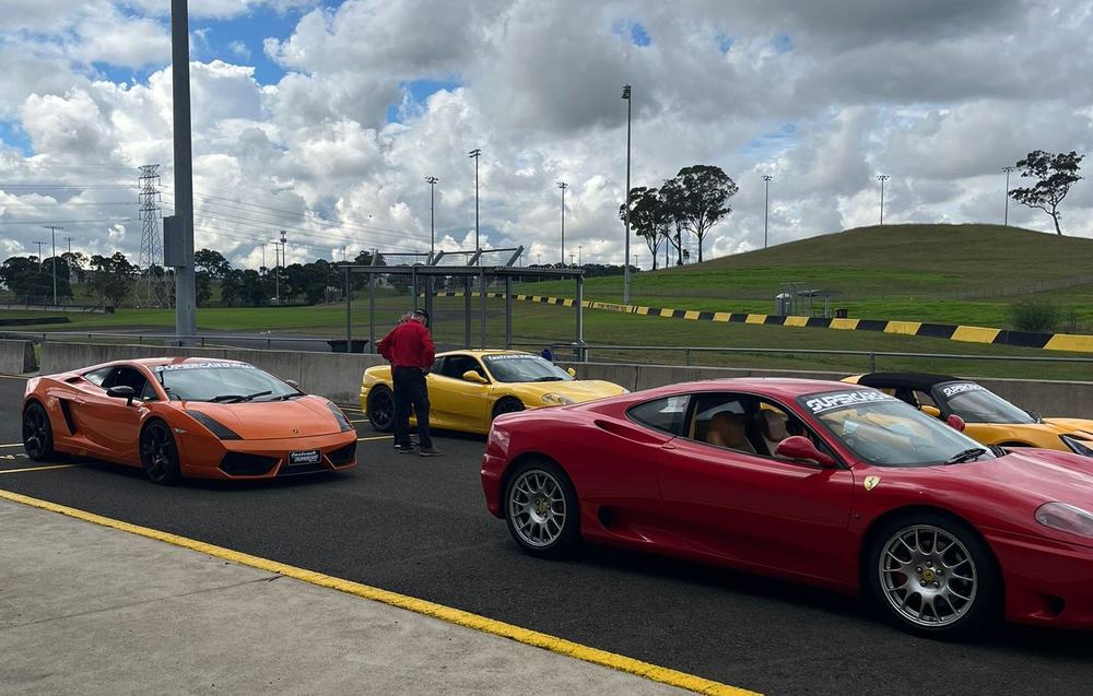 Supercars lined up in pit lane at Sydney Motorsport Park